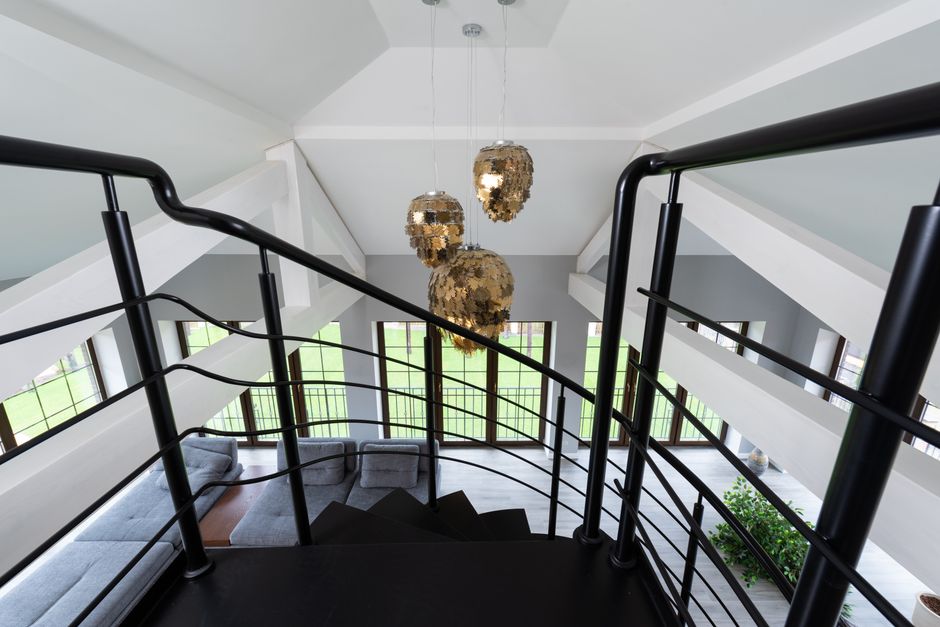 Moderne Loft-Stil Pendelleuchte in einem urbanen Wohnraum mit hohen Decken und unverputzten Wänden.